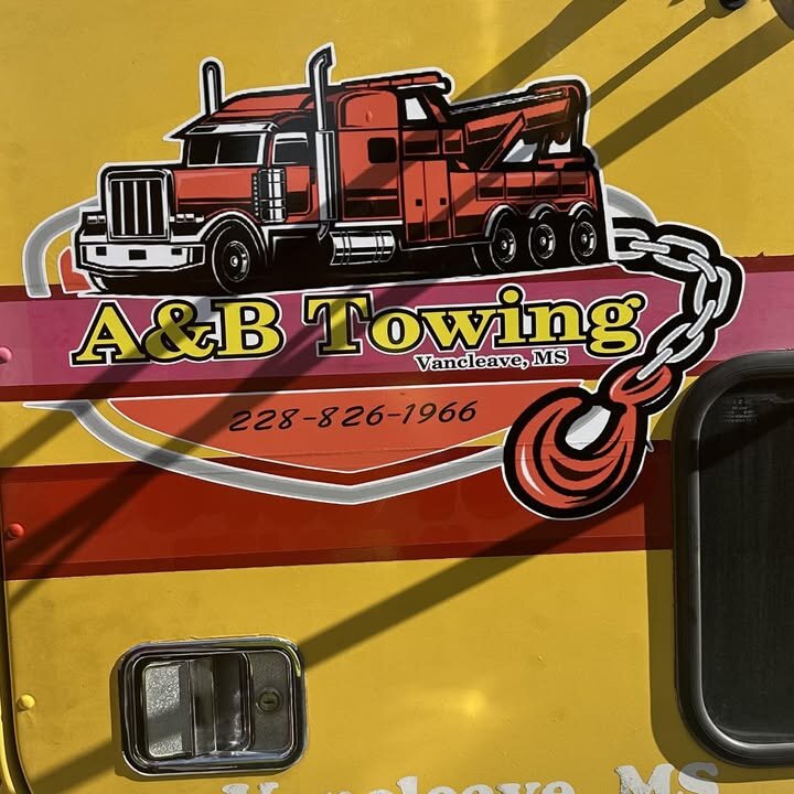 A&B Towing door decal: a red wrecker, a chain and tow hook, and the phone number